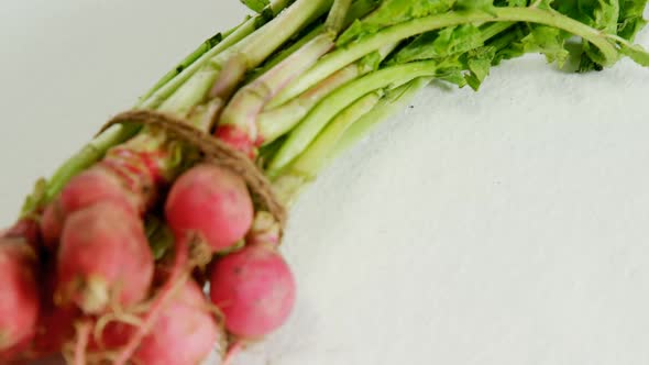 Bunch of radish placed against white background 