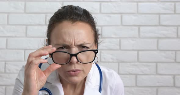 Woman physician in white suit. 