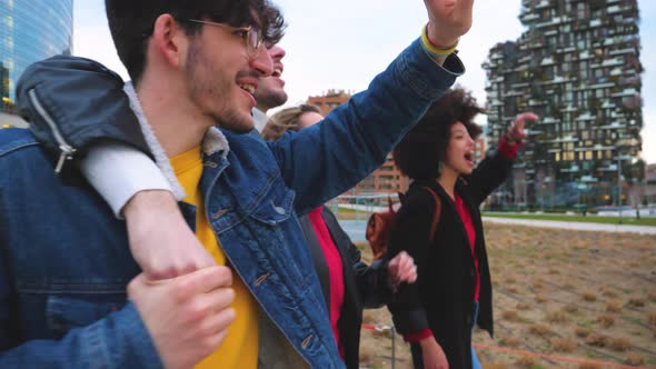 Group of friends tourist walking together hugging outdoors