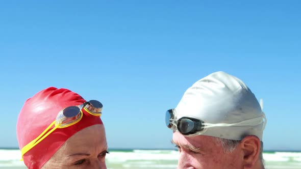 Senior couple interacting with each other at the beach