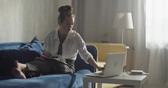 Student Typing on Laptop and Studying at Home