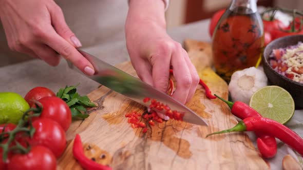 Woman Hands Slicing Chopping Chili Pepper at Domestic Kitchen