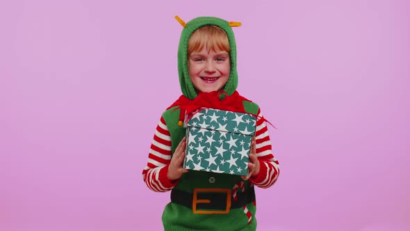 Cheerful Girl in Christmas Santa Costume Getting Present Gift Box Expressing Amazement Happiness