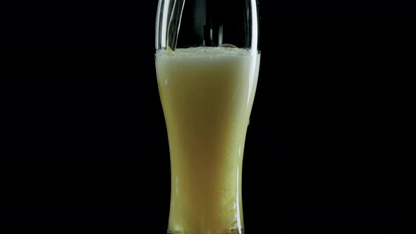 Light Beer In A Glass On A Black Background Close Up