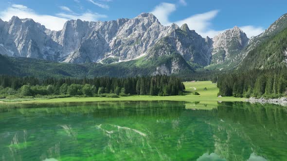 Emerald lake at Fusine with Mangart mountain