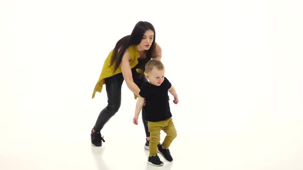 Kid Steps on the Floor in a Spacious Room, White Background, Slow Motion