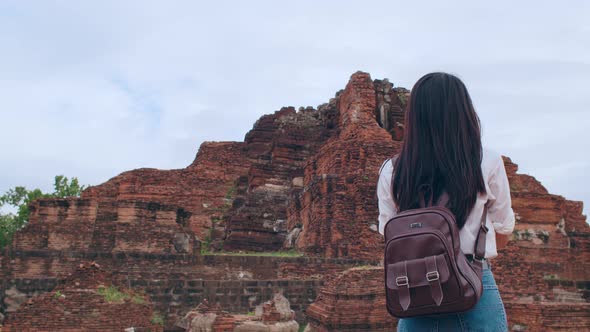 Japanese backpacker female enjoy her journey at amazing landmark in traditional city.