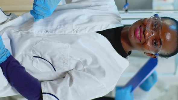 Vertical Video Black Doctor Woman Smiling at Camera Sitting in Scientific Lab