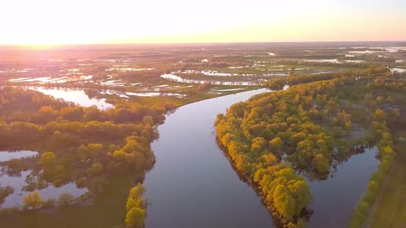 Beautiful View of the Picturesque Winding River Surrounded By Forest at Sunset