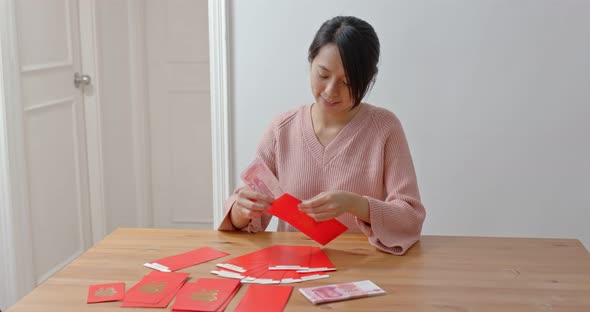 Woman fill money with red pocket