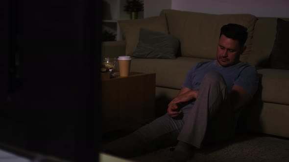 Man Falling Asleep in front of TV at Night