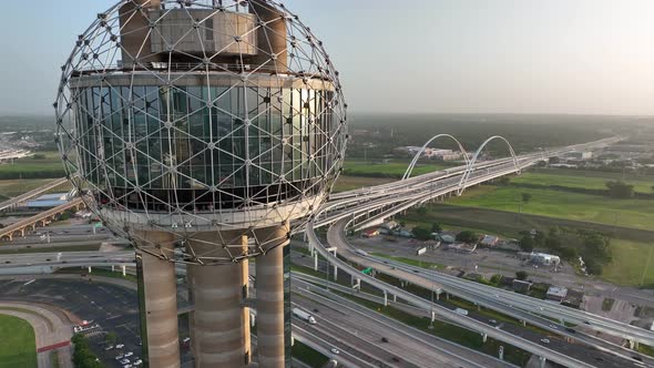 Rising aerial reveal of Reunion Tower and Margaret McDermott Bridge and Interstate 30 in Dallas Texa