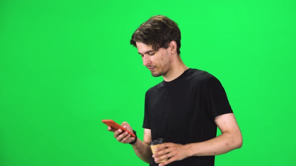 Brunette Man Walking and Watching on the Phone Something, Drinking Coffee, Chroma Key