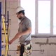 Electrician contractor with electric cable at a construction site. - VideoHive Item for Sale
