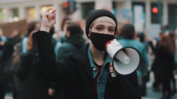 Woman with Face Mask and Megaphone Supporting Anti-racism Protests.