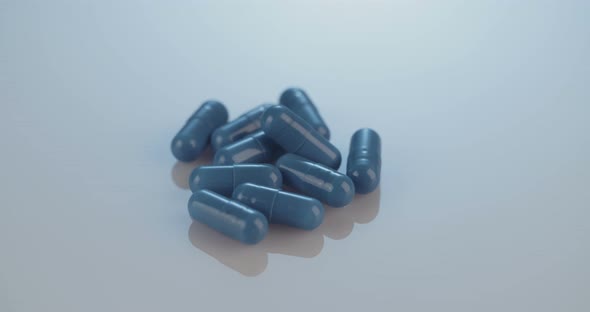 Prescription drugs - Capsules, pills, tablets on reflective background