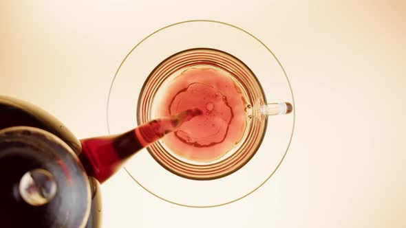 Pouring Black Tea in Cup Top View