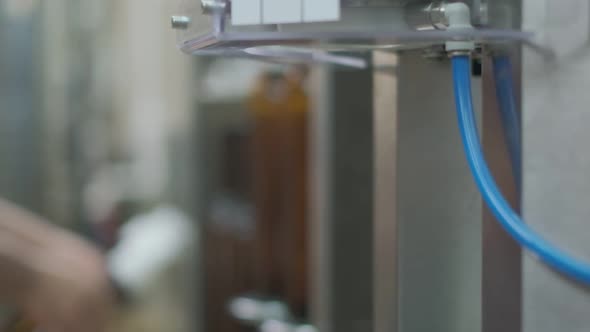 Wine Cork is Inserted Into the Bottle on a Machine