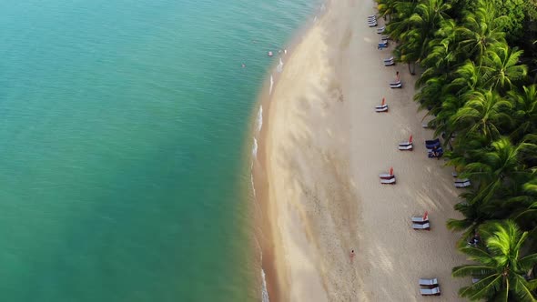 Blue Lagoon and Sandy Beach with Palms. Aerial View of Blue Lagoon and Sun Beds on Sandy Beach