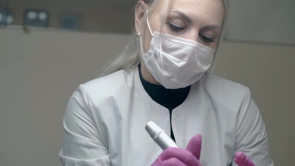 Concentrated Cosmetologist in Sterile Gloves Breathes Deeply