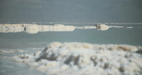 Tracking shot of salt deposits on the banks of the Dead Sea in israel