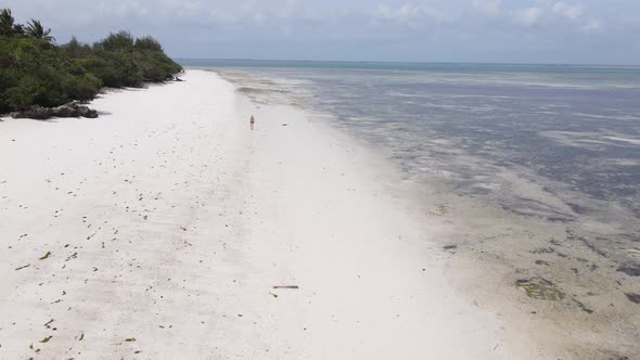 Woman Walking on the Beach at Low Tide Low Tide in Zanzibar