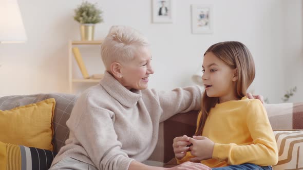 Caucasian Girl Chatting with Loving Granny at Home