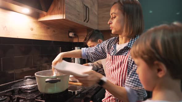 Caucasian Mother and Son Preparing Dinner Together at Home