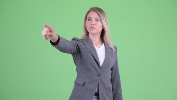 Happy Young Beautiful Blonde Businesswoman Pointing Finger