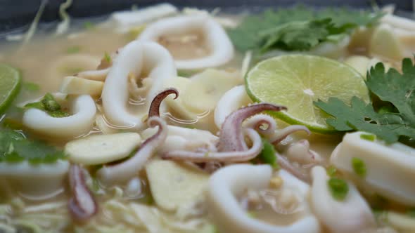 Close-Up Footage of Hot and Sour Squid in Chilli, Garlic and Lime Soup