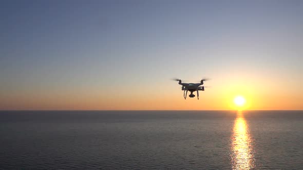 Drone Flies Over the Sea Toward the Sunset