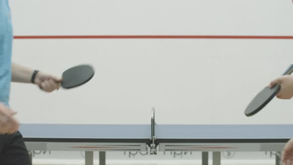 Unrecognizable Young Man and Woman Shaking Hands in Gym in Front of Table for Ping-pong. Handshake