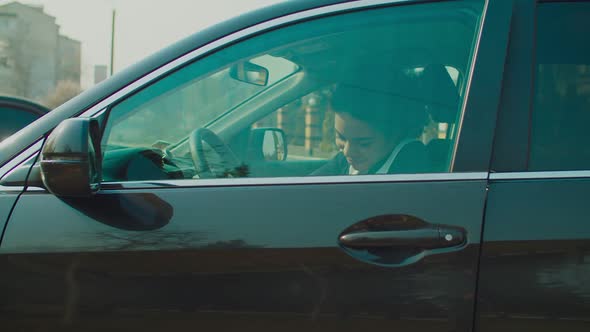 Smiling Pretty Female Driver Opening Car Door