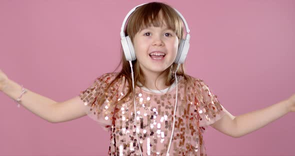 Happy Smiling Young Girl Dancing and Singing in Headphones