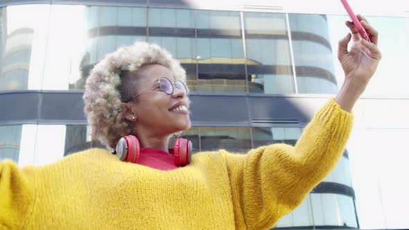 Smiling African American Woman Making Video Call on the Street with Smart Phone