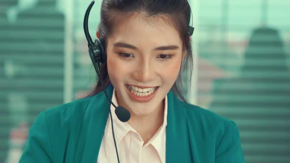 Businesswoman Wearing Headset Working Actively in Office