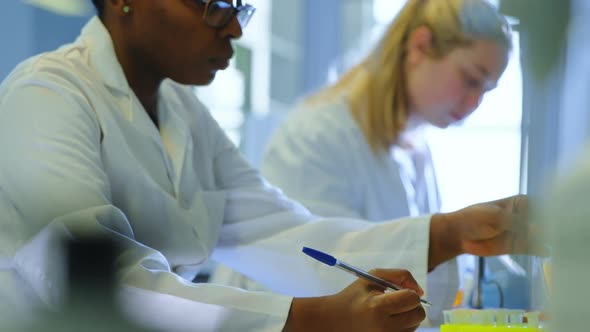 Attentive female scientist experimenting in laboratory