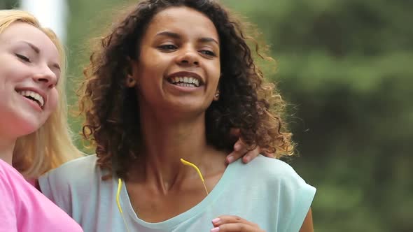 Two Cute Girls Making Dance Moves, Hugging One Another at Outdoor Party