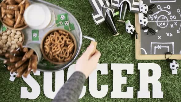 salty snacks and drinks on the metal tray for soccer party.