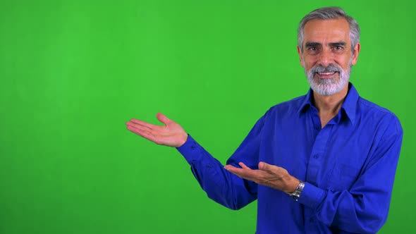 Old Senior Man Introduces Something - Green Screen - Studio