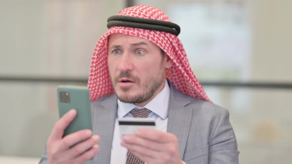 Portrait Middle Aged Arab Businessman with Online Payment Failure on Smartphone