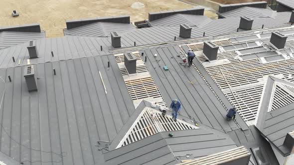 Aerial Flying Over the Wooden Roof of an Unfinished House. Construction