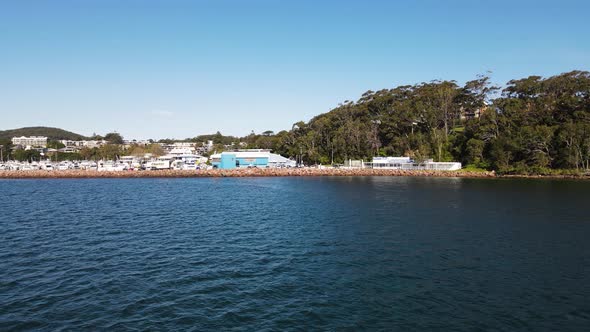 Fast revealing high view over water of a popular scuba diving spot the pipeline at Nelson Bay Port S