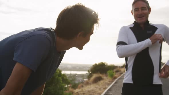 Father and young adult son enjoying outdoor activities together