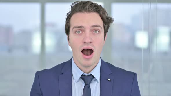 Portrait of Surprised Young Businessman Feeling Shocked