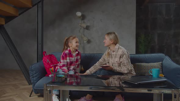 Excited Little Girl Sharing with Mom About School Day