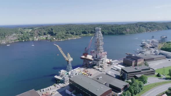 Aerial Slomo Panning high around a Small Loading Dock in Norway, during Sunny weather