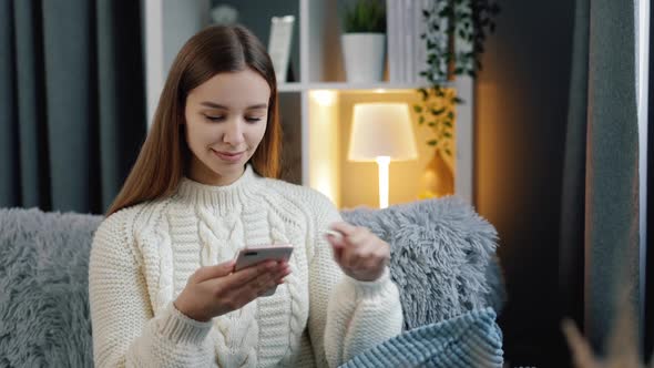 Woman Using Smartphone at Home