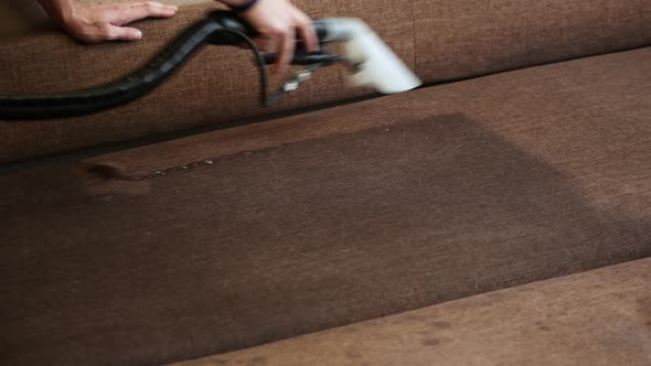 Close-up of Washing Cleaner Cleans the Sofa and Removes Dirt, Professional Cleaning Service