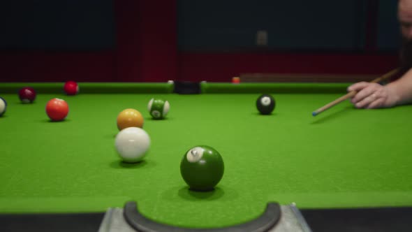 Billiard Table Man Hits White Ball with Cue and It Rolls Knocks Against Green Green Rolls Into
